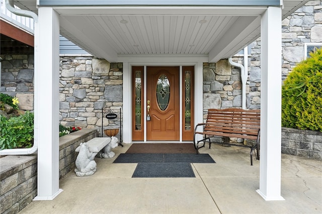 1419 Bullion Rd, Victory Twp, PA 16342 - view of exterior entry featuring stone siding and a porch