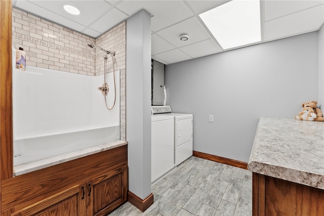 1419 Bullion Rd, Victory Twp, PA 16342 - bathroom featuring washing machine and dryer, a shower, a paneled ceiling, and wood finished floors