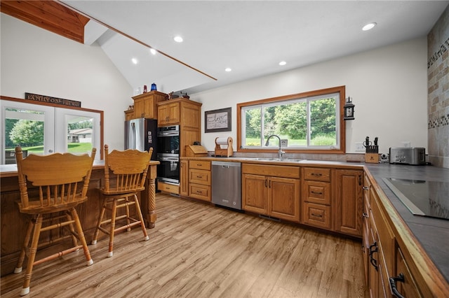 1419 Bullion Rd, Victory Twp, PA 16342 - kitchen with brown cabinetry, light wood finished floors, stainless steel appliances, recessed lighting, and high vaulted ceiling