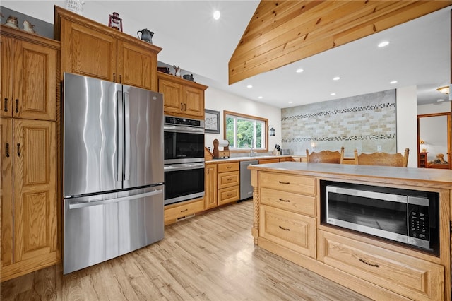 1419 Bullion Rd, Victory Twp, PA 16342 - kitchen with stainless steel appliances, light countertops, light wood-style flooring, vaulted ceiling, and recessed lighting