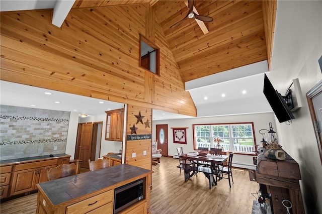 1419 Bullion Rd, Victory Twp, PA 16342 - kitchen featuring tile counters, stainless steel microwave, light wood-type flooring, high vaulted ceiling, and brown cabinetry