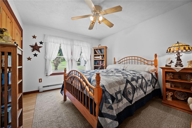 1419 Bullion Rd, Victory Twp, PA 16342 - bedroom with a baseboard radiator, ceiling fan, and light wood finished floors