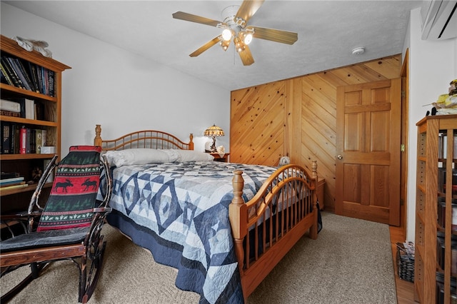 1419 Bullion Rd, Victory Twp, PA 16342 - carpeted bedroom featuring a wall mounted air conditioner, wooden walls, and ceiling fan