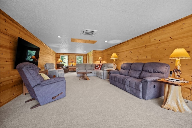 1419 Bullion Rd, Victory Twp, PA 16342 - carpeted living area featuring a textured ceiling, wood walls, and recessed lighting