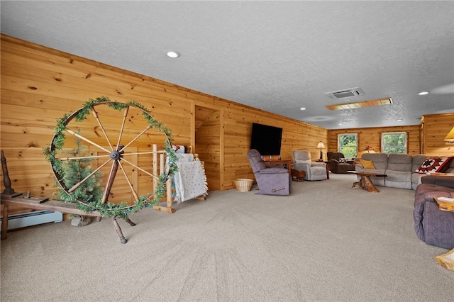 1419 Bullion Rd, Victory Twp, PA 16342 - living room featuring carpet floors, wood walls, a textured ceiling, recessed lighting, and a baseboard heating unit