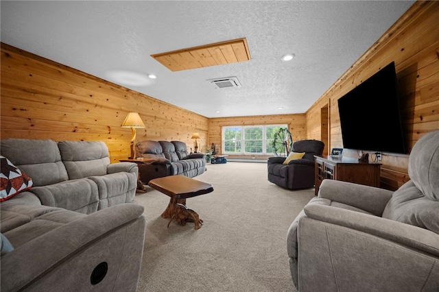 1419 Bullion Rd, Victory Twp, PA 16342 - carpeted living area featuring a textured ceiling, wooden walls, and recessed lighting