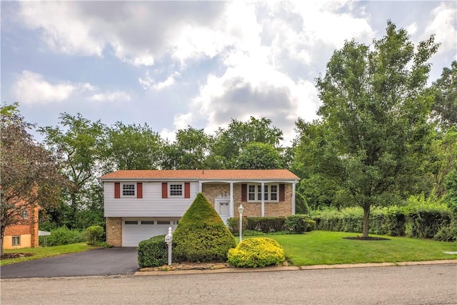 428 Englewood Dr, Ross Twp, PA 15237 - raised ranch with brick siding, a garage, asphalt driveway, and a front yard