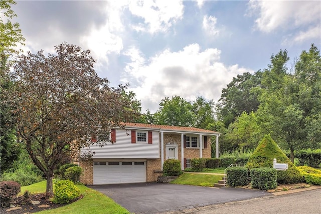 428 Englewood Dr, Ross Twp, PA 15237 - raised ranch featuring brick siding, an attached garage, and driveway