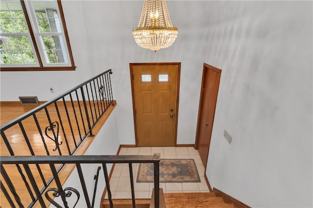 428 Englewood Dr, Ross Twp, PA 15237 - tiled foyer entrance with stairs, a chandelier, and a towering ceiling