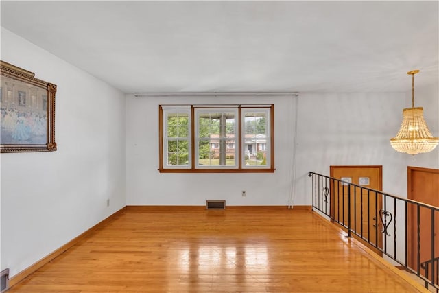 428 Englewood Dr, Ross Twp, PA 15237 - unfurnished room with light wood finished floors and a chandelier