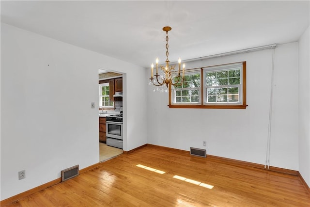 428 Englewood Dr, Ross Twp, PA 15237 - empty room with a chandelier and light wood-style flooring