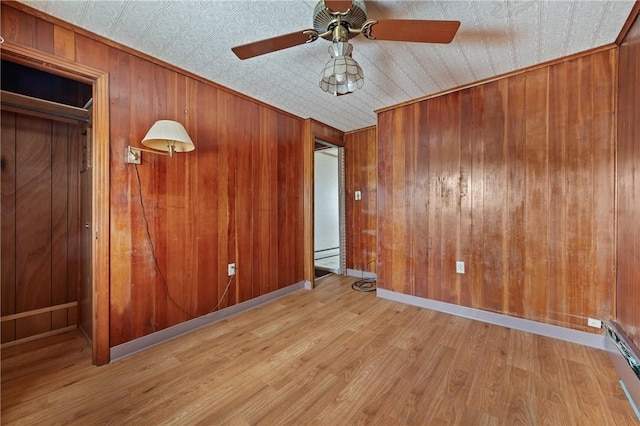 4614 Carroll St, Bloomfield, PA 15224 - unfurnished room with wood finished floors, an ornate ceiling, ceiling fan, baseboard heating, and wooden walls