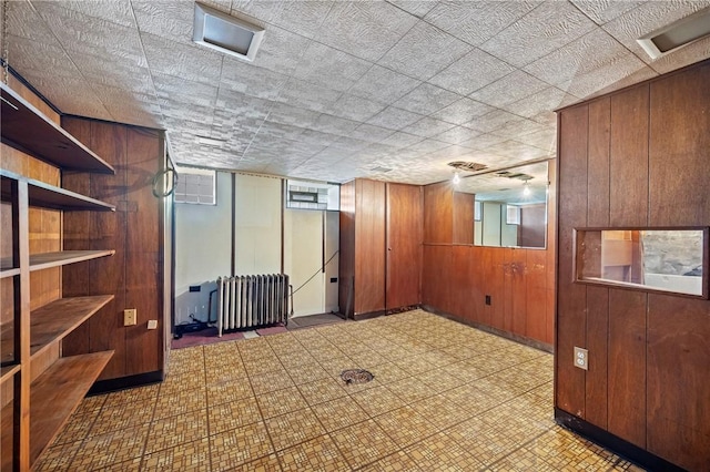 4614 Carroll St, Bloomfield, PA 15224 - finished below grade area featuring tile patterned floors, wooden walls, and radiator