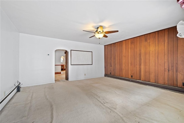 4614 Carroll St, Bloomfield, PA 15224 - carpeted spare room with arched walkways, ceiling fan, baseboard heating, and wood walls