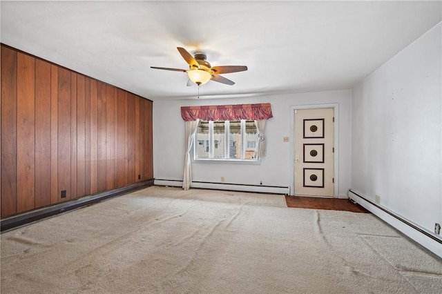 4614 Carroll St, Bloomfield, PA 15224 - carpeted spare room with a ceiling fan, wooden walls, and a baseboard radiator