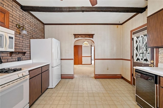 4614 Carroll St, Bloomfield, PA 15224 - kitchen featuring beam ceiling, white appliances, light floors, light countertops, and wooden walls