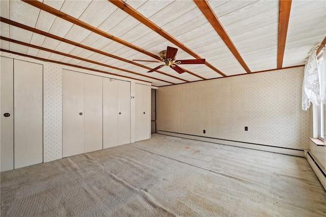 4614 Carroll St, Bloomfield, PA 15224 - unfurnished bedroom featuring wallpapered walls, carpet flooring, baseboard heating, two closets, and a baseboard radiator