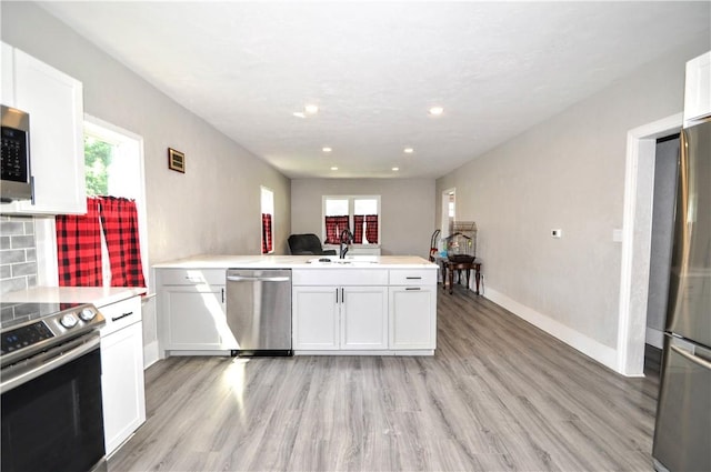 315 Ohio St, Rostraver, PA 15012 - kitchen with a peninsula, healthy amount of natural light, light wood-style floors, and recessed lighting