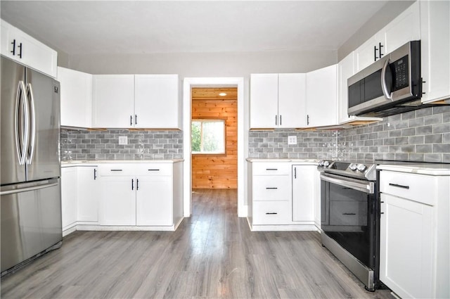 315 Ohio St, Rostraver, PA 15012 - kitchen with appliances with stainless steel finishes, light countertops, decorative backsplash, and light wood-style flooring
