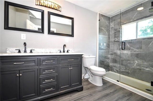 315 Ohio St, Rostraver, PA 15012 - bathroom featuring double vanity, a stall shower, and wood finished floors
