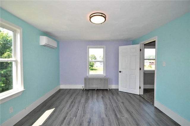 315 Ohio St, Rostraver, PA 15012 - unfurnished room with radiator heating unit, wood finished floors, and a wall unit AC