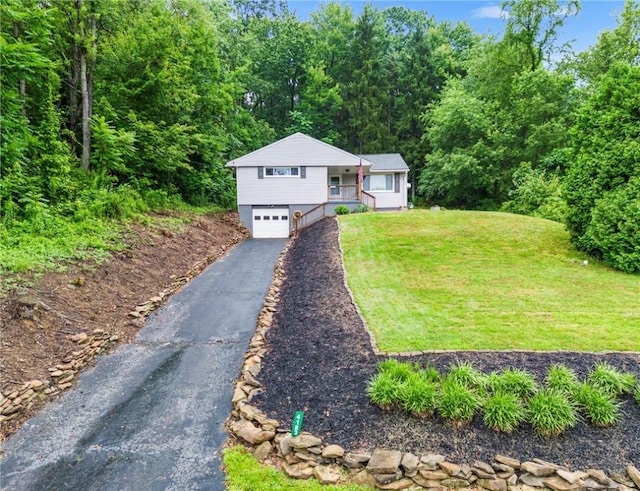 4183 Marion Hill Rd, Daugherty Twp, PA 15066 - view of front of home with an attached garage, asphalt driveway, a front yard, and a wooded view