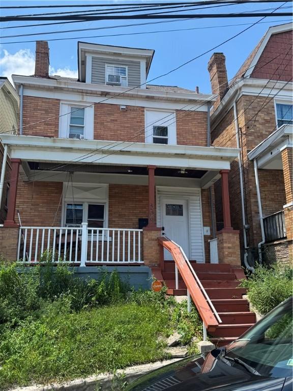 509 Hays Ave, Mount Oliver, PA 15210 - american foursquare style home featuring brick siding, a porch, a chimney, and stairway
