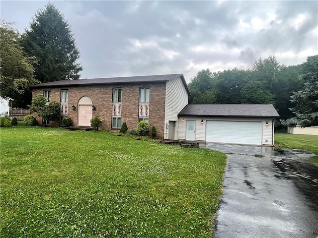 31 Aylesworth Way, Liberty Twp, PA 16127 - split foyer home featuring asphalt driveway, a front lawn, a garage, and brick siding