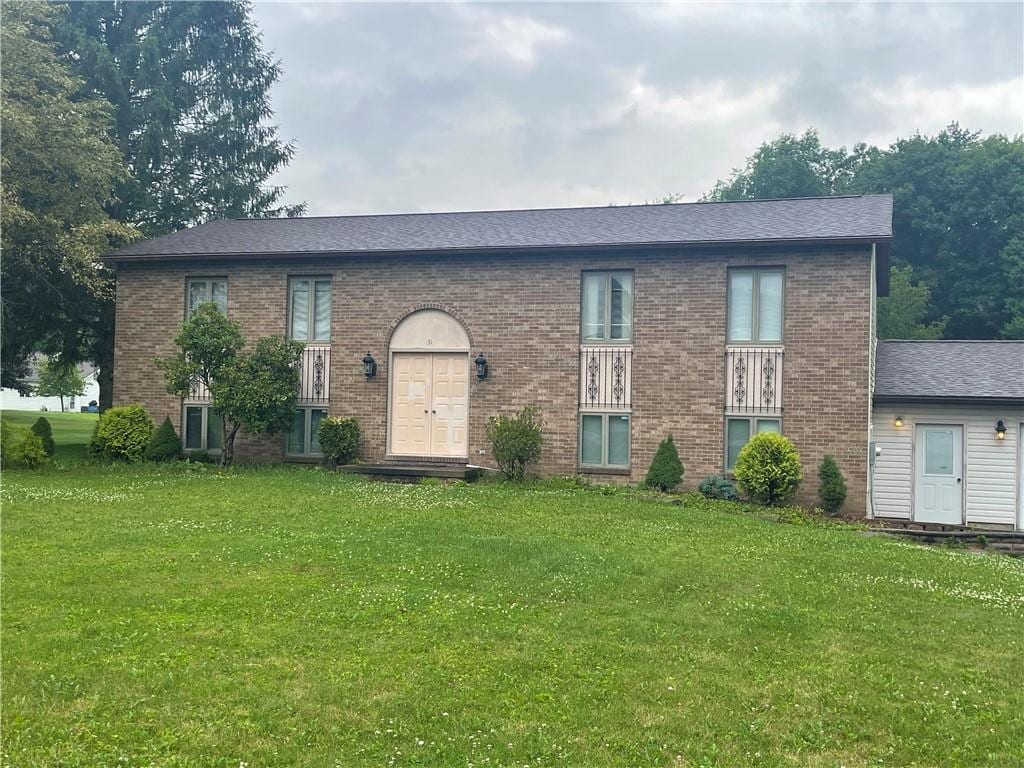 31 Aylesworth Way, Liberty Twp, PA 16127 - view of front facade featuring a front lawn, brick siding, and roof with shingles