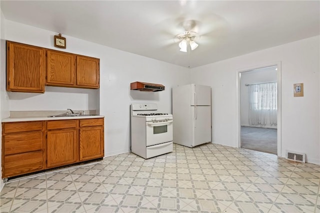 1113 Mary Ann St, South Side, PA 15203 - kitchen featuring white appliances, light countertops, brown cabinetry, light flooring, and a ceiling fan
