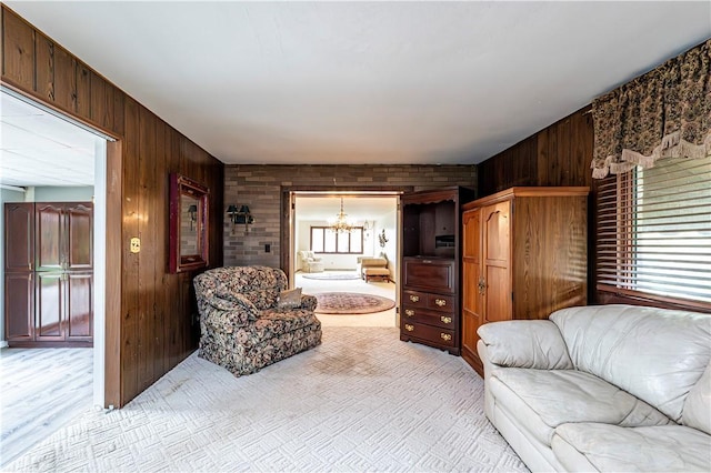4045 Blue Willow, Hempfield Twp, PA 15642 - living area featuring a chandelier, wood walls, and light colored carpet