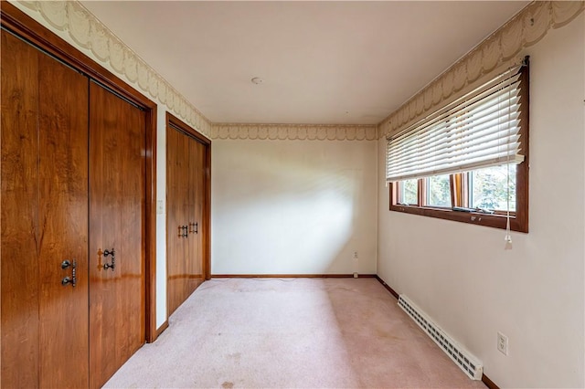 4045 Blue Willow, Hempfield Twp, PA 15642 - unfurnished bedroom with baseboard heating, light colored carpet, and two closets