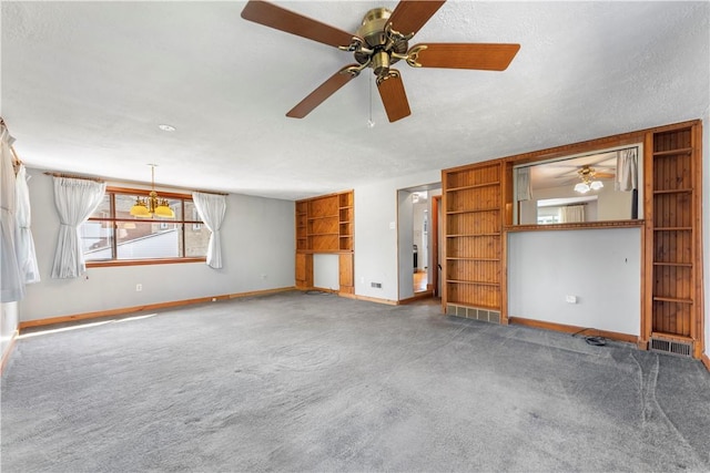 1926 Worcester Dr, Pittsburgh, PA 15243 - unfurnished living room featuring carpet floors, ceiling fan, built in shelves, a chandelier, and a textured ceiling