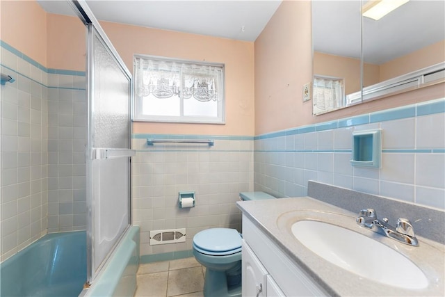 1926 Worcester Dr, Pittsburgh, PA 15243 - full bath with tile patterned floors, vanity, tile walls, and bath / shower combo with glass door