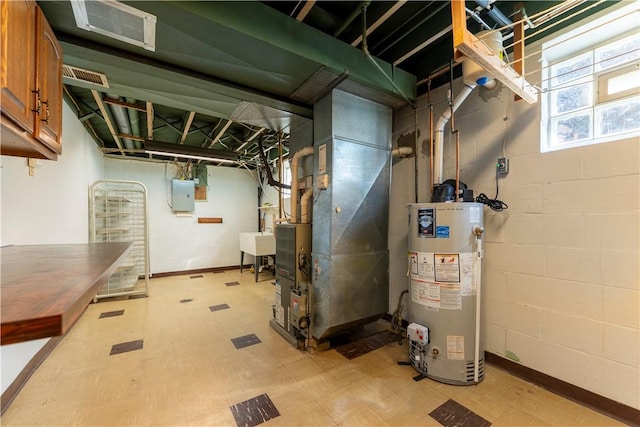 1926 Worcester Dr, Pittsburgh, PA 15243 - basement with light flooring, gas water heater, heating unit, and concrete block wall