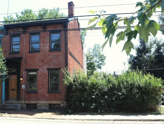 611 Jacksonia St, Central North Side, PA 15212 - view of side of home with brick siding, a chimney, and entry steps