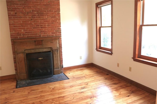 611 Jacksonia St, Central North Side, PA 15212 - unfurnished living room featuring a fireplace, hardwood / wood-style floors, and plenty of natural light