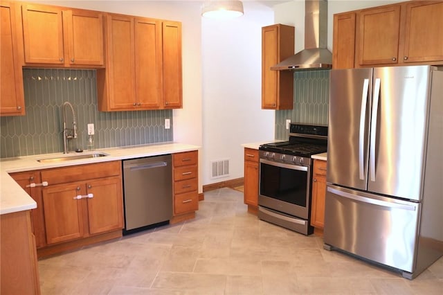 611 Jacksonia St, Central North Side, PA 15212 - kitchen featuring appliances with stainless steel finishes, wall chimney exhaust hood, tasteful backsplash, light countertops, and brown cabinetry