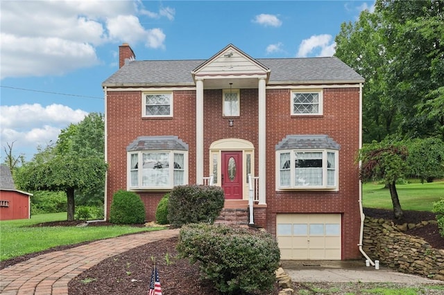 714 Colonial, Washington Twp, PA 15613 - view of front of house featuring brick siding, a chimney, a garage, and a front lawn