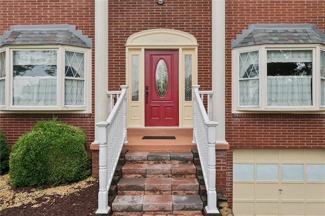 714 Colonial, Washington Twp, PA 15613 - doorway to property with brick siding and an attached garage