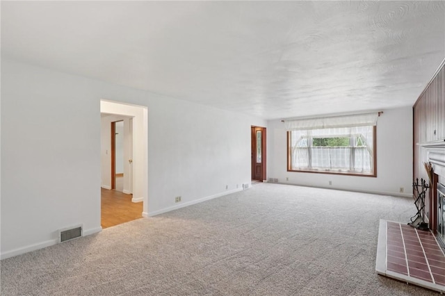 714 Colonial, Washington Twp, PA 15613 - unfurnished living room featuring carpet flooring and a fireplace