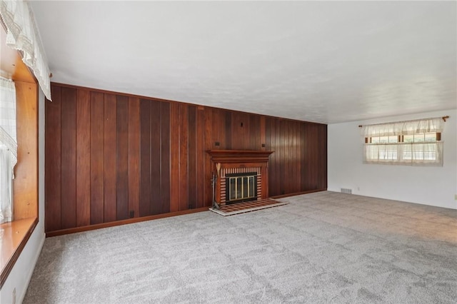 714 Colonial, Washington Twp, PA 15613 - unfurnished living room with carpet, wood walls, and a fireplace