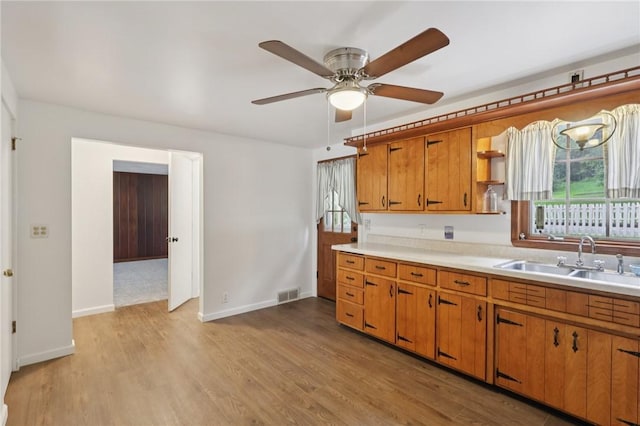 714 Colonial, Washington Twp, PA 15613 - kitchen featuring brown cabinetry, light countertops, a ceiling fan, light wood-style flooring, and open shelves