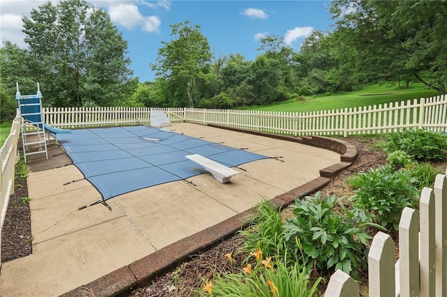 714 Colonial, Washington Twp, PA 15613 - view of pool with a diving board, a water slide, a patio area, and view of wooded area
