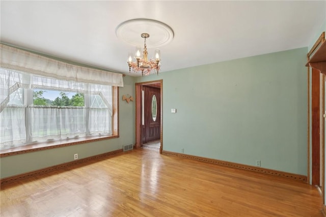 714 Colonial, Washington Twp, PA 15613 - spare room featuring a chandelier and light wood-style floors
