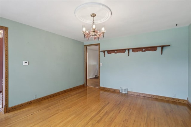 714 Colonial, Washington Twp, PA 15613 - unfurnished room with a chandelier and light wood-style floors