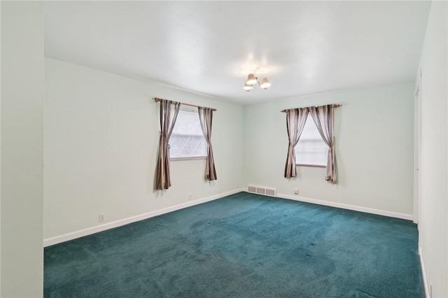 714 Colonial, Washington Twp, PA 15613 - spare room featuring healthy amount of natural light and dark colored carpet