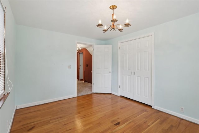 714 Colonial, Washington Twp, PA 15613 - unfurnished bedroom featuring a chandelier, wood finished floors, and a closet