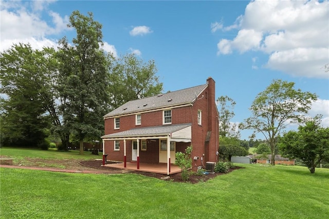 714 Colonial, Washington Twp, PA 15613 - back of property featuring covered porch, brick siding, a lawn, and a chimney