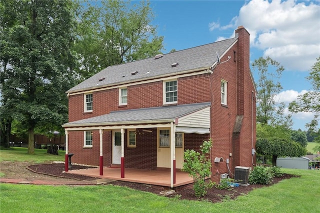 714 Colonial, Washington Twp, PA 15613 - back of property featuring a chimney, a yard, brick siding, covered porch, and a shingled roof